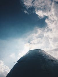 Low angle view of airplane flying against sky