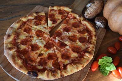 High angle view of pizza on cutting board