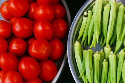 High angle view of tomatoes and okras for sale in market