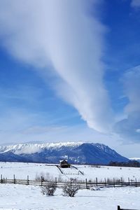 Scenic view of snow covered mountains against sky