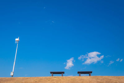 Low angle view of built structure on beach against blue sky