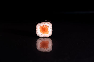 Close-up of sushi against black background