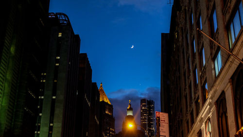 Low angle view of illuminated buildings against sky