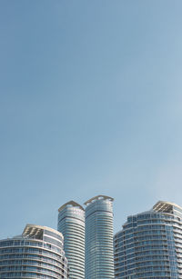 Low angle view of skyscrapers against clear sky