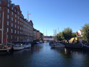 Boats in harbor with buildings in background