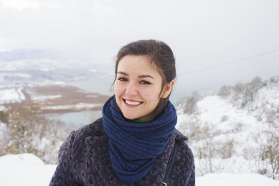 Portrait of happy young woman in warm clothes