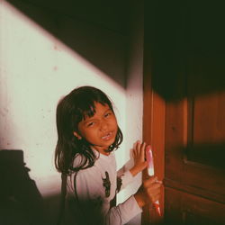 Girl looking away while standing at home