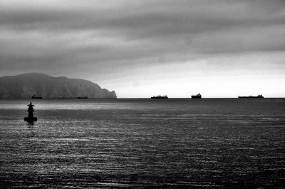 Scenic view of sea against cloudy sky