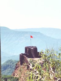 Scenic view of sea and mountains against clear sky