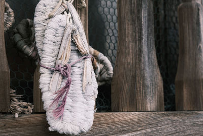 Close-up of rope tied to wooden fence