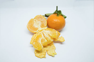 Close-up of orange fruit against white background