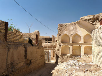 Old ruins of houses against clear sky