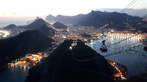 High angle view of illuminated cityscape against sky during sunset