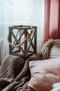 Low section of man relaxing on bed at home