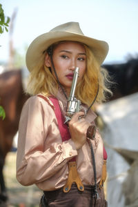 Portrait of woman wearing hat standing outdoors