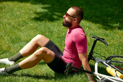 Side view of woman exercising on field