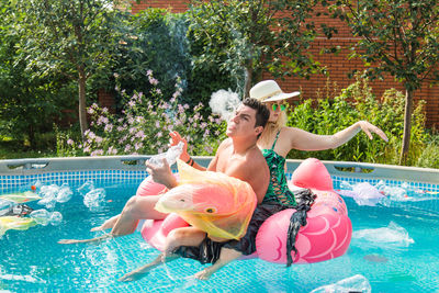 Woman sitting in swimming pool