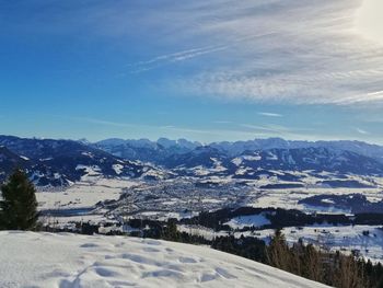 Scenic view of snow covered mountains against sky