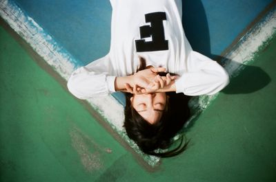 High angle view of woman lying down on terrace