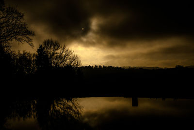 Silhouette of landscape against cloudy sky