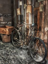 Bicycle parked against wall in old building