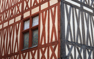 Corner of an old half-timbered house with two colored wooden lintels