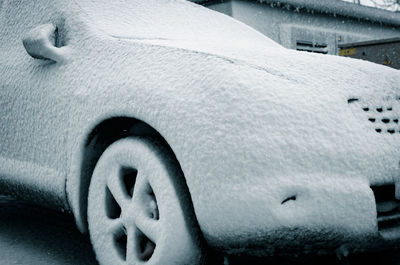 Close-up of snow covered car