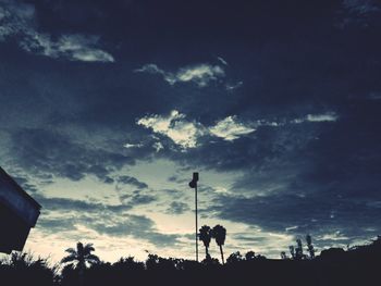High section of silhouette trees against scenic sky