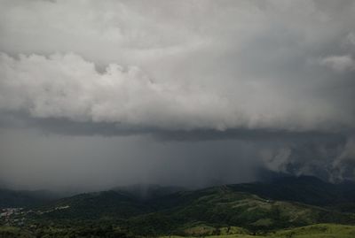 Scenic view of storm clouds over landscape