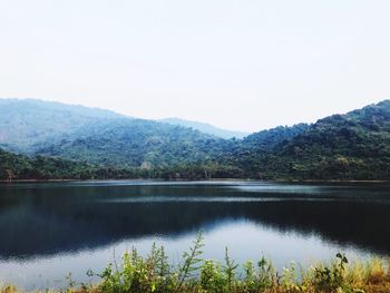 Scenic view of lake and mountains against clear sky