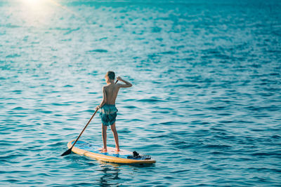 Man surfing on boat in sea