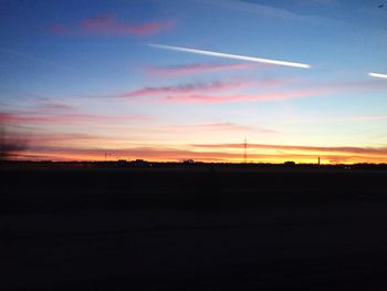 Silhouette of landscape against sky at sunset