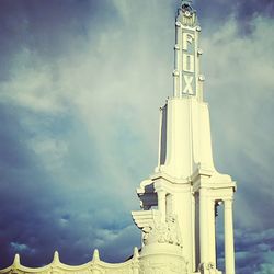 Low angle view of a building against cloudy sky