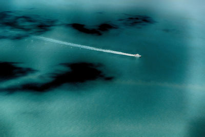 High angle view of airplane flying over sea