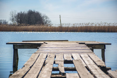 Pier on lake against sky