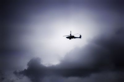 Helicopter flying against sky