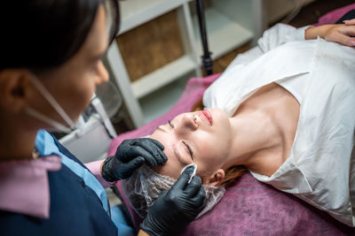 Midsection of doctor examining patient in hospital