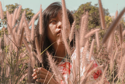 Woman looking away by plants