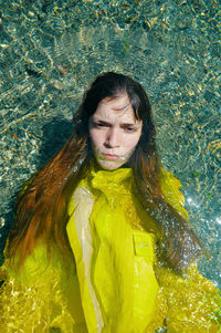 Portrait of young woman standing in lake