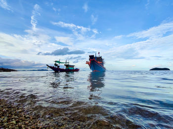 Scenic view of sea against sky. boat fishing at the harbor port