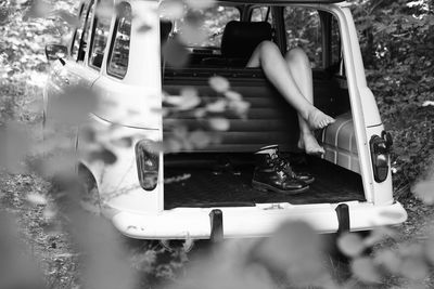 Midsection of woman using mobile phone in bus
