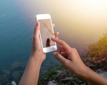 Midsection of man using mobile phone