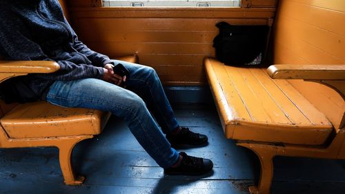 Low section of man sitting on bench