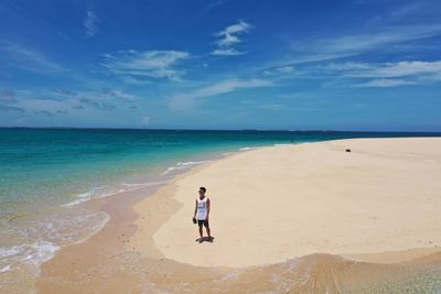 Woman on beach against sky