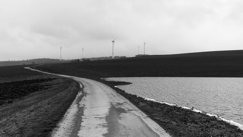 Road by landscape against sky