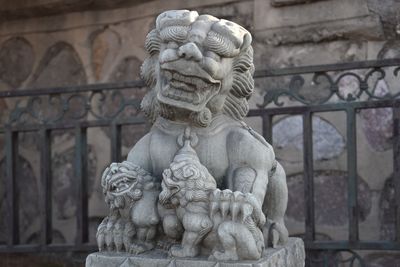 Close-up of statue against stone wall