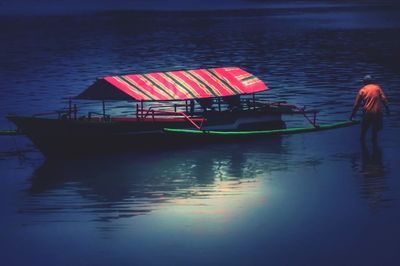 Rear view of men on boat in sea