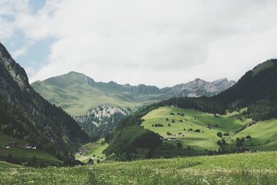 View of countryside landscape against mountain range