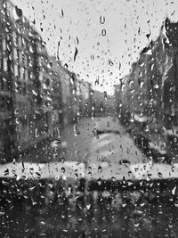 Raindrops on glass window in rainy season