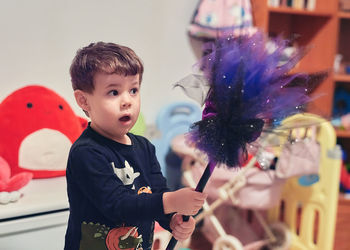 Happy young boy is playing with a witches broom